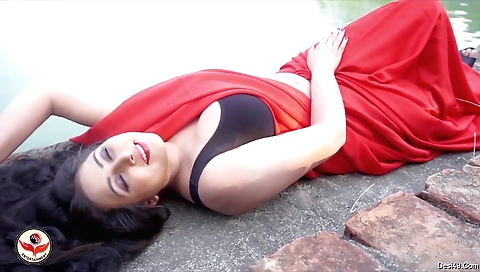 Big boobs brunette babe in black tunic in an outdoor scene