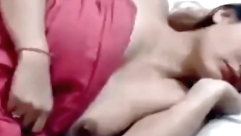 A brunette in a red dress is taking care of her pussy