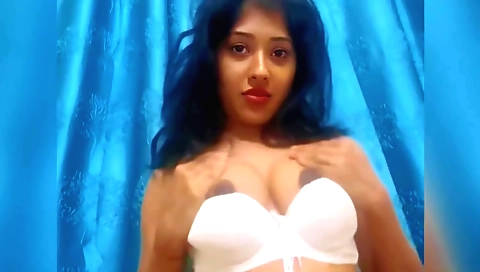 Indian beauty in a black dress takes off her clothes